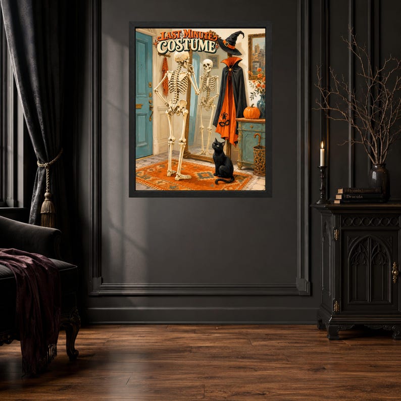 May include: A framed wall art print titled LAST MINUTE COSTUME featuring a skeleton standing before a mirror, a black cat, a witch hat, and an orange and black cape. The scene includes a blue door, an orange rug, and a pumpkin on a wooden cabinet.