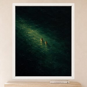 May include: A framed wall art print featuring a dark, deep green ocean scene with two figures swimming in a bright, narrow shaft of light that cuts through the center of the water. The frame is white and rectangular, surrounding the dark artwork.