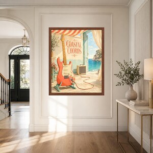 May include: A framed wall art print titled Coastal Chords featuring a coral-coloured electric guitar on a stand, connected by a cable to a small amplifier. The scene depicts an open doorway looking out onto a sunny Mediterranean coastal view.