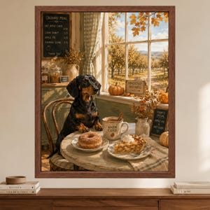 May include: A framed wall art print depicting a black and tan dachshund sitting at a round table with a doughnut and a slice of apple pie. A mug labelled WARM CIDER sits nearby. The scene features an orchard view through a window with autumn foliage.