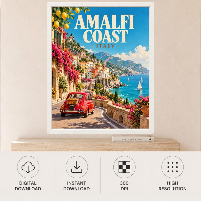 May include: A framed travel poster featuring the Amalfi Coast in Italy. The scene shows a red vintage car on a coastal road, vibrant pink bougainvillea, yellow lemons, and sailboats on the blue sea. The text reads AMALFI COAST ITALY.