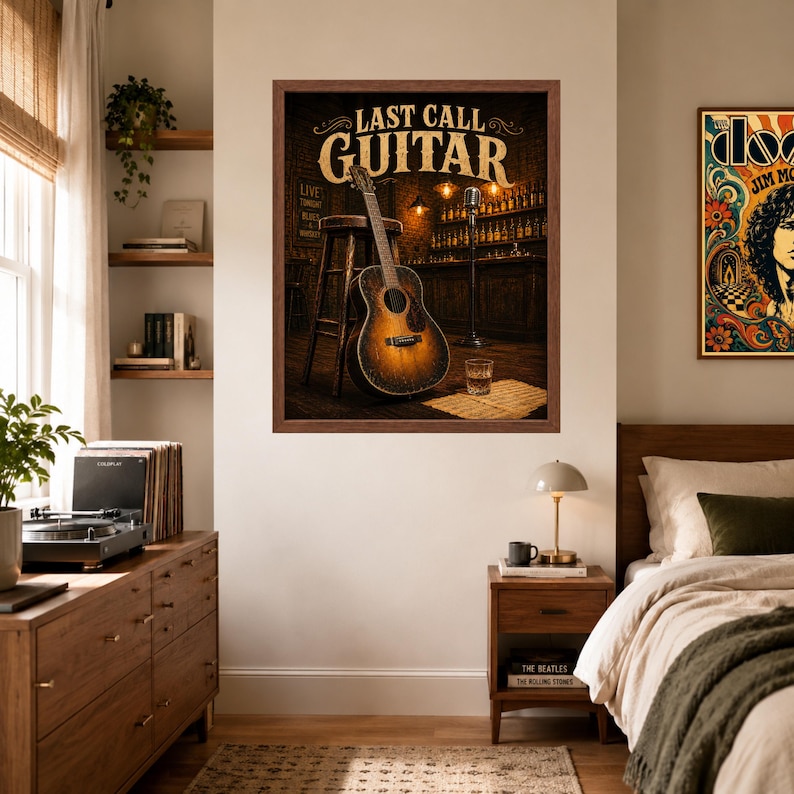 May include: A framed wall art print titled LAST CALL GUITAR featuring an acoustic guitar leaning against a wooden stool in a dimly lit bar setting with a microphone stand, a glass of amber liquid, and shelves of bottles in the background.