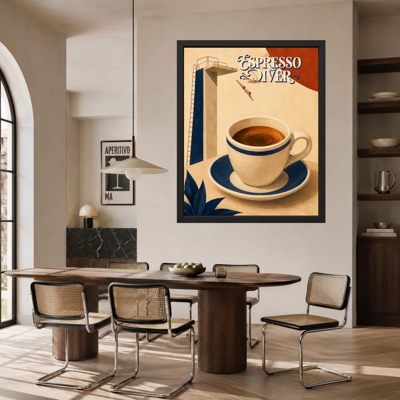 May include: A framed wall art print titled Espresso Diver featuring a cream-colored coffee cup on a matching saucer with blue trim. The background depicts a diving board and a diver against a beige backdrop with a dark red circular accent.