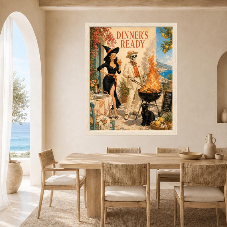 May include: A framed wall art print titled DINNER'S READY featuring a woman in a black witch costume and a skeleton in a suit grilling over a fire. A black cat sits nearby on a patio overlooking the sea with lemon trees and a chalkboard menu.
