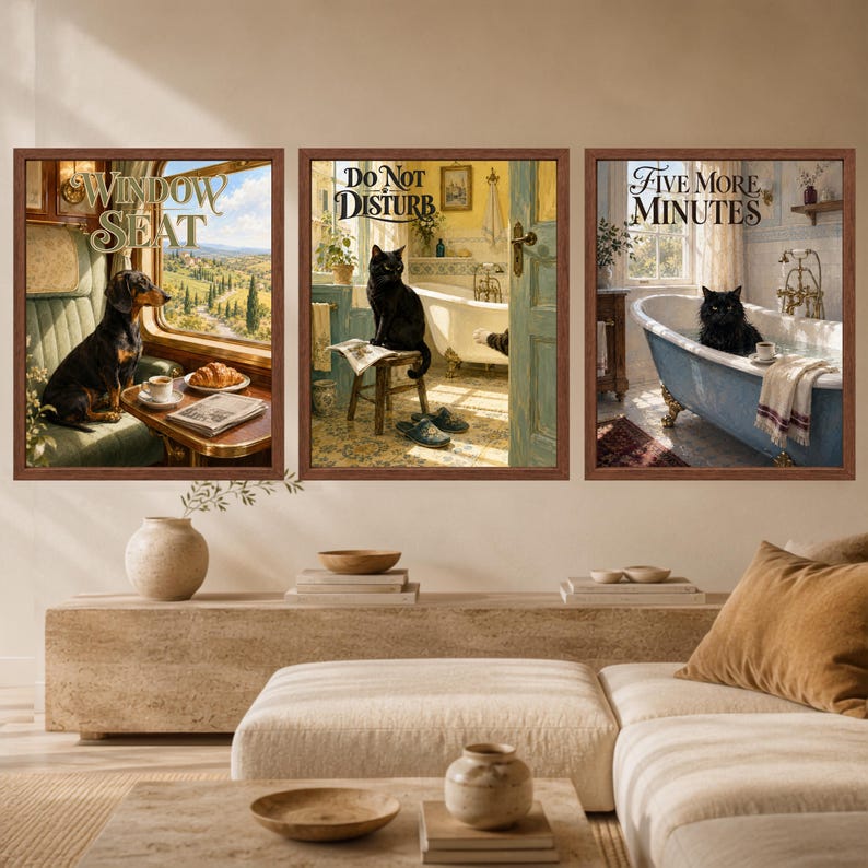 May include: Three framed wall art prints featuring a dachshund sitting by a train window with the text WINDOW SEAT, a black cat on a stool in a bathroom with the text DO NOT DISTURB, and a black cat in a blue bathtub with the text FIVE MORE MINUTES.