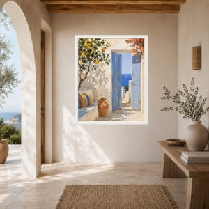 May include: A framed wall art print depicting a Mediterranean scene with an open blue door, a lemon tree, a terracotta vase, and a striped cushion on a stone bench, all overlooking a bright blue sea with a distant sailboat under a clear sky.