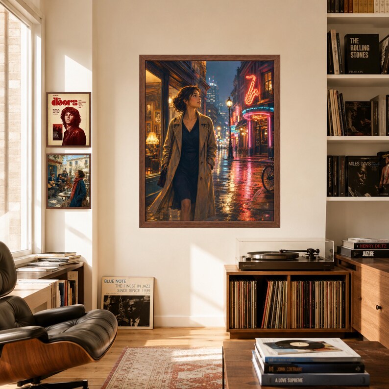 May include: A framed wall art print depicting a person in a tan trench coat walking down a rain-slicked city street at night, illuminated by neon signs including a glowing red saxophone, with two smaller framed prints displayed on the wall nearby.