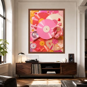 May include: A framed wall art print featuring a vibrant collage of pink, red, and cream vinyl records, a pair of pink headphones, a small pink record player, and decorative elements including a white flower, stars, and hearts on a pink background.