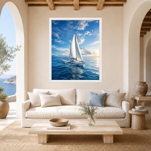 May include: A framed wall art print featuring a white sailboat navigating deep blue ocean waters under a bright sky with scattered clouds. The scene captures the vessel in motion, creating a gentle wake on the surface of the sea.