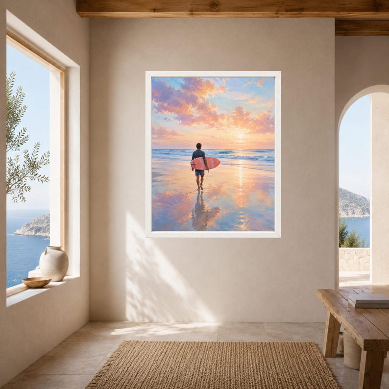 May include: A framed wall art print depicting a person walking on a wet sandy beach at sunset while carrying a pink surfboard. The sky is filled with soft pink and orange clouds, and the ocean waves are gentle, reflecting the vibrant colors.