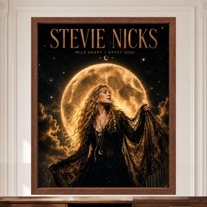 May include: A framed wall art print featuring Stevie Nicks in a black lace outfit against a large, glowing full moon and starry night sky. The text STEVIE NICKS, WILD HEART, and GYPSY SOUL is printed in gold at the top of the dark, atmospheric image.