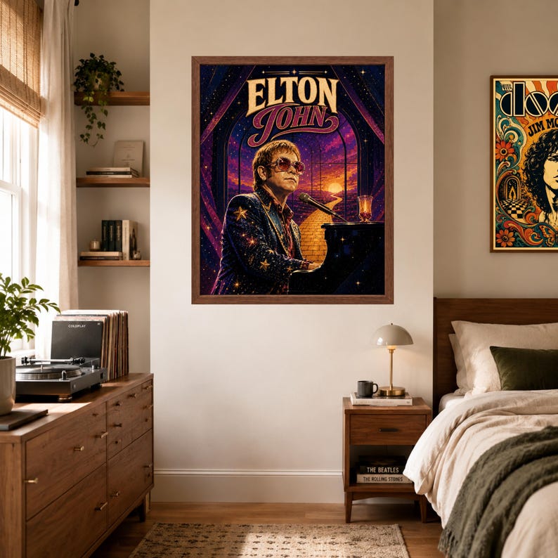 May include: A framed rectangular wall poster featuring a stylized illustration of Elton John playing a piano. The artwork displays the text ELTON JOHN in bold lettering above the musician, set against a vibrant purple and orange cosmic background.