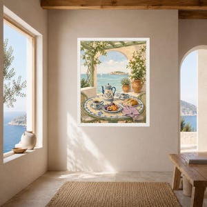 May include: A framed wall art print depicting a Mediterranean terrace scene with a round tiled table, a blue and white teapot, two cups, and a plate of fruit. The background shows a coastal view with a pergola, potted plants, and the sea.