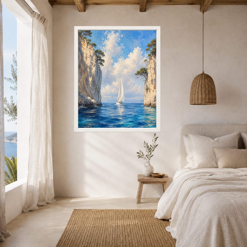 May include: A framed wall art print depicting a sailboat navigating through a narrow passage between two tall, light-colored rocky cliffs. The scene features deep blue water, a bright sky with white clouds, and small green trees atop the cliffs.