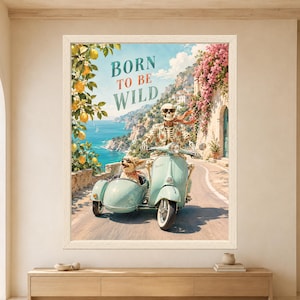 Framed Born to Be Wild skeleton wall art featuring a sunglasses-wearing skeleton riding a mint green vintage scooter with a dog in the sidecar along a sunny Mediterranean coastal road.
