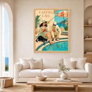 May include: A framed wall art print titled CASTING CALL featuring a woman in a witch hat and a skeleton in a suit sitting by a swimming pool. A black cat sits nearby while the skeleton holds a fishing rod with a small orange pumpkin on the line.