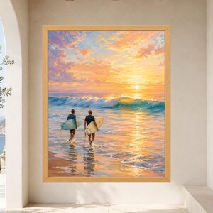May include: A framed wall art print depicting two individuals walking into the ocean at sunset, each carrying a surfboard. The scene features a vibrant orange and yellow sky, turquoise waves, and golden reflections on the wet sand.
