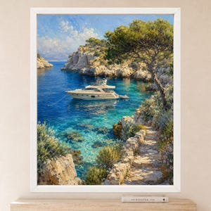 May include: A framed landscape painting depicting a white motor yacht anchored in a clear blue Mediterranean cove. The scene features rugged limestone cliffs, a stone pathway along the rocky shore, and a large pine tree overlooking the water.
