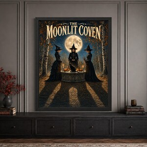Framed witch coven Halloween wall art featuring three women in black witch dresses gathered around a candlelit stone altar with a black cat beneath a huge full moon, surrounded by birch trees, autumn leaves and “The Moonlit Coven” typography.