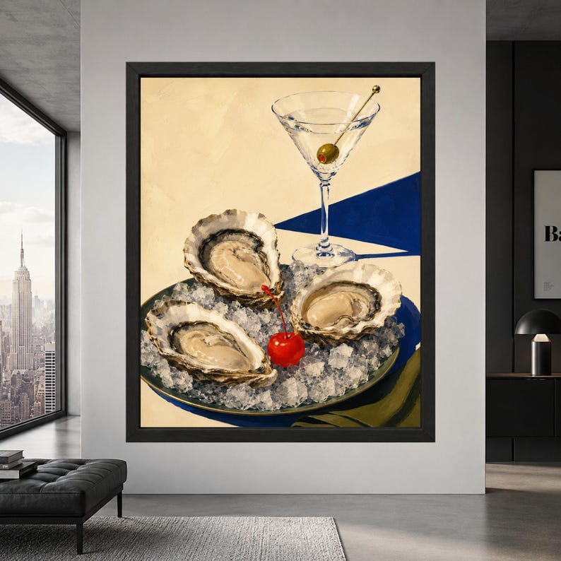 Framed oyster and martini wall art showing three oysters on crushed ice beside a clear martini with green olive, red cocktail cherry and bold cobalt blue accents on a cream background.