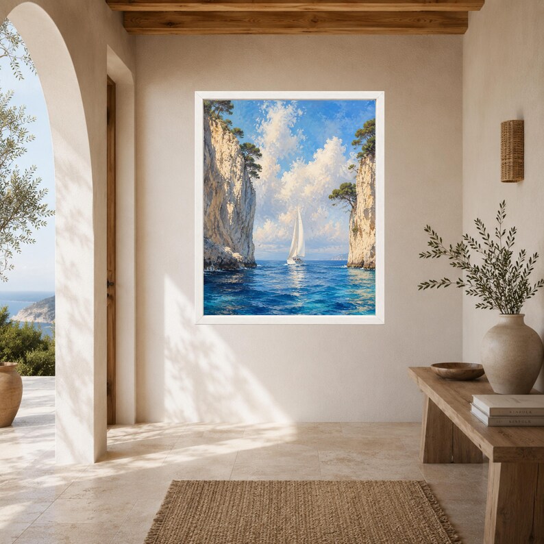 May include: A framed wall art print depicting a white sailboat navigating through a narrow passage between two tall, light-colored rocky cliffs. The scene features deep blue ocean water, a bright sky with fluffy white clouds, and green trees.