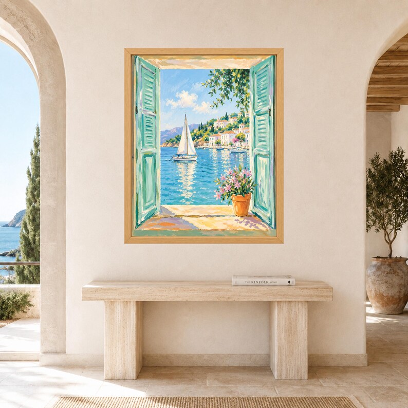 May include: A framed wall art print depicting an open window with teal shutters looking out onto a coastal scene. The painting features a white sailboat on blue water, a hillside village with white buildings, and a potted plant with pink flowers.