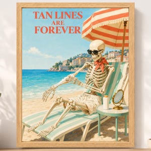May include: A framed wall art print featuring a skeleton wearing black sunglasses and a red neckerchief, sitting on a striped beach chair under a red and white striped umbrella. The text TAN LINES ARE FOREVER is printed in red at the top.