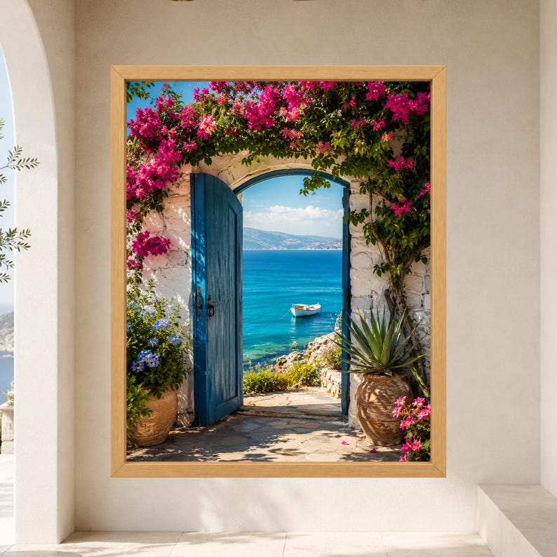 Framed Greek island wall art showing an open blue wooden door in a whitewashed stone arch covered with pink bougainvillea, overlooking turquoise Aegean water and a small white boat.