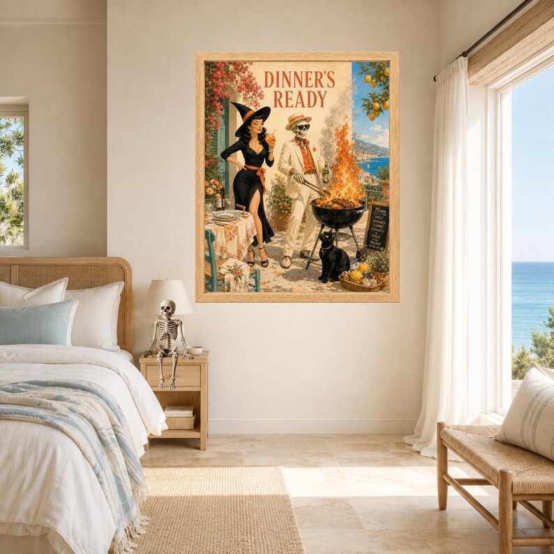 May include: A framed wall art print titled DINNER'S READY featuring a woman in a black dress and witch hat standing next to a skeleton in a white suit grilling over an open fire. A black cat sits nearby on a patio overlooking a coastal landscape.