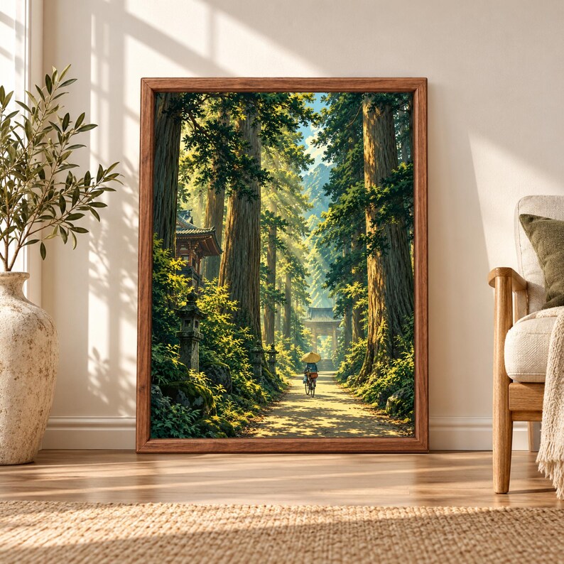Framed Japanese forest wall art showing a sunlit cedar tree path with stone lanterns, traditional temple architecture and a lone cyclist beneath a parasol.