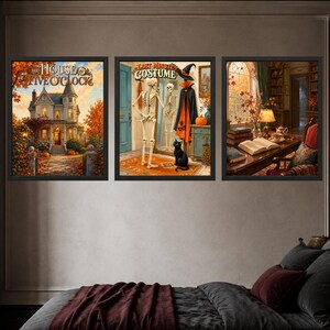 May include: Three framed wall art prints featuring autumn themes. The left print shows a house with the text 'THE HOUSE OF FIVE O'CLOCK'. The center print depicts a skeleton and black cat with the text 'LAST MINUTE COSTUME'. The right print shows a library.