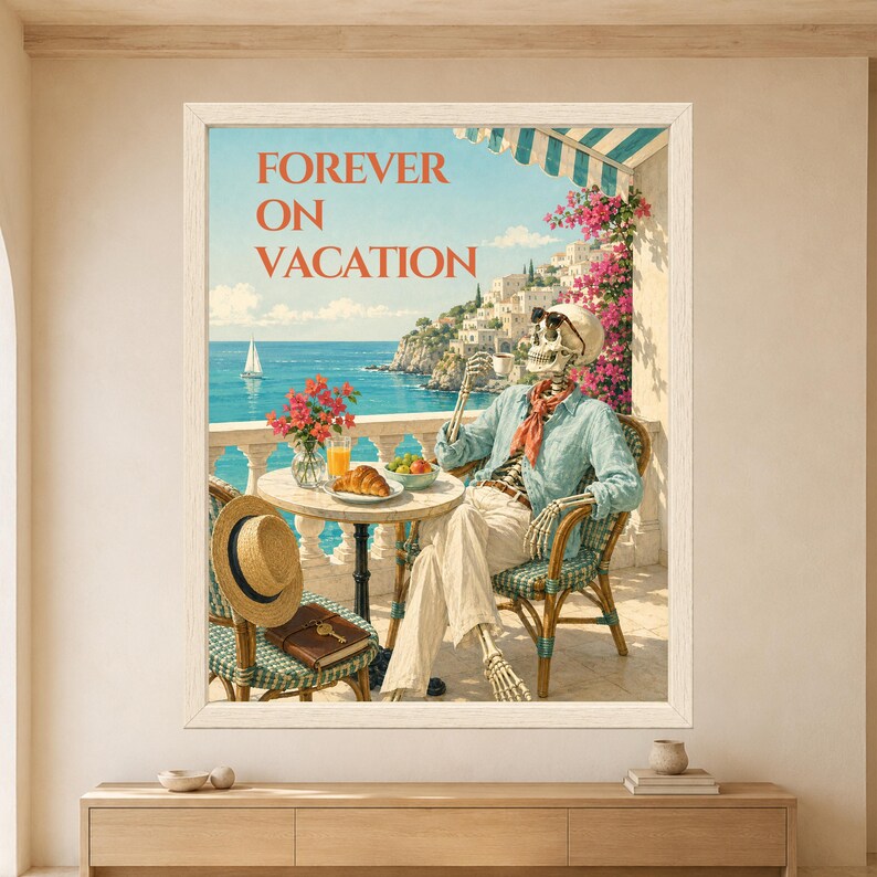 Framed Forever on Vacation skeleton wall art featuring a sunglasses-wearing skeleton drinking coffee on a sunny Mediterranean terrace with turquoise sea, croissant, flowers and coastal village.
