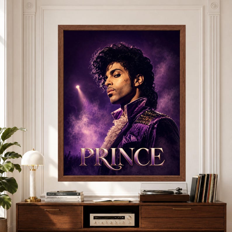 Framed Prince wall art featuring a vintage-inspired 1980s music portrait in a purple stage jacket with ruffled shirt, dramatic violet concert lighting, smoky atmosphere and large elegant Prince typography above a record player console.