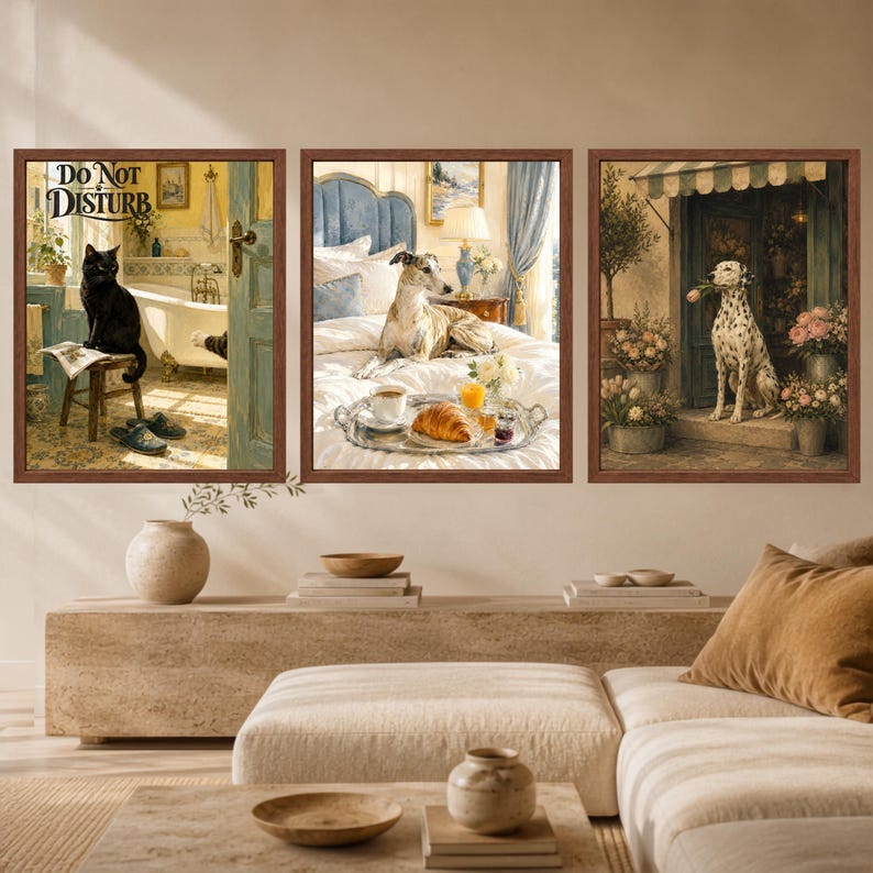 May include: A set of three framed wall art prints. The first shows a black cat on a stool in a bathroom with the text DO NOT DISTURB. The second depicts a dog on a bed with a breakfast tray. The third features a Dalmatian dog holding a flower.