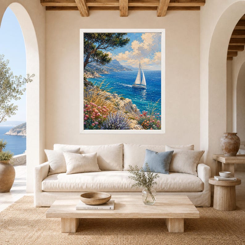 May include: A framed wall art print featuring a coastal landscape painting with a white sailboat on deep blue water, rocky cliffs, and vibrant pink and purple wildflowers under a bright blue sky with fluffy white clouds in a sunny setting.