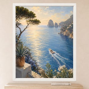 May include: A framed landscape painting depicting a coastal scene with a blue sea, a small motorboat leaving a wake, rocky cliffs, and a sunset sky. In the foreground, a potted agave plant sits on a stone ledge near white flowering bushes.