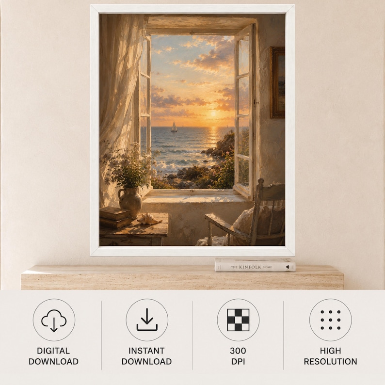 May include: A framed wall art print depicting an open window view of a sunset over the ocean with a sailboat, sheer curtains, a vase of flowers on a table, and a wooden chair. Below the frame sits a book titled The Kinfolk Home on a shelf.