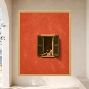 May include: A framed wall art print featuring a vibrant orange textured wall with an open window. The window has dark green louvered shutters and shows a person sitting on the sill reading a book inside a dimly lit room.