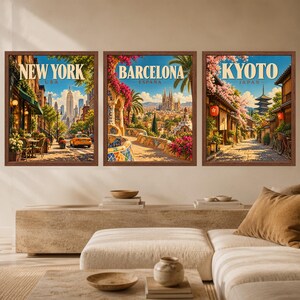 May include: Three framed wall art prints featuring travel illustrations of New York, USA, Barcelona, Espa&ntilde;a, and Kyoto, Japan. Each rectangular print displays a vibrant city scene with detailed architecture, colorful flowers, and clear text labels.
