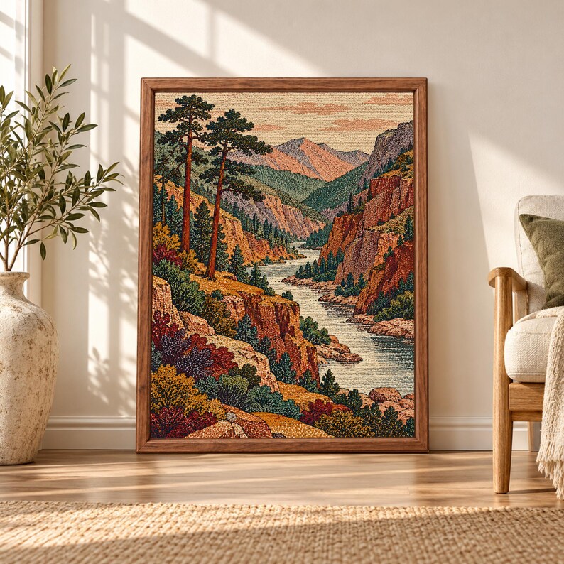 Framed vintage mountain landscape wall art showing a winding river through pine-covered canyon cliffs, layered mountains and warm rust, green and ochre foliage.