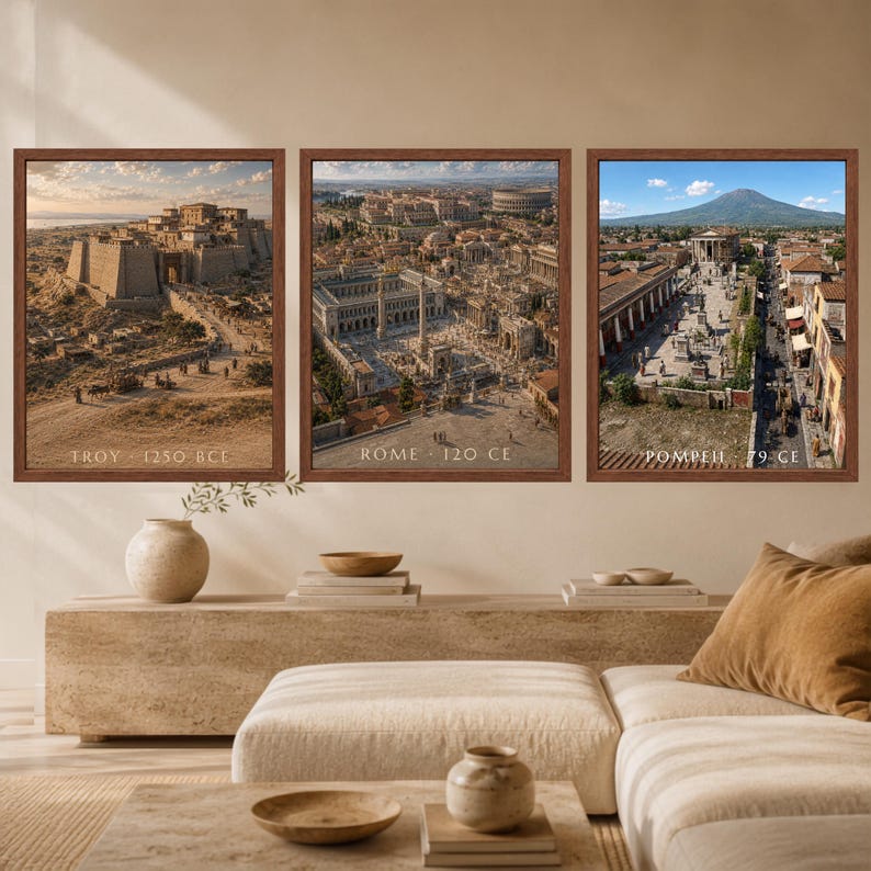 May include: Three framed wall art prints depicting historical cityscapes. The left print shows Troy 1250 BCE, the center print shows Rome 120 CE, and the right print shows Pompeii 79 CE. Each print features detailed architectural illustrations.