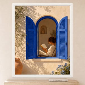May include: A framed wall art print depicting an arched window with vibrant blue shutters set into a beige stucco wall. A person sits inside the window frame reading an open book. An olive tree and blue flowers are visible in the foreground.