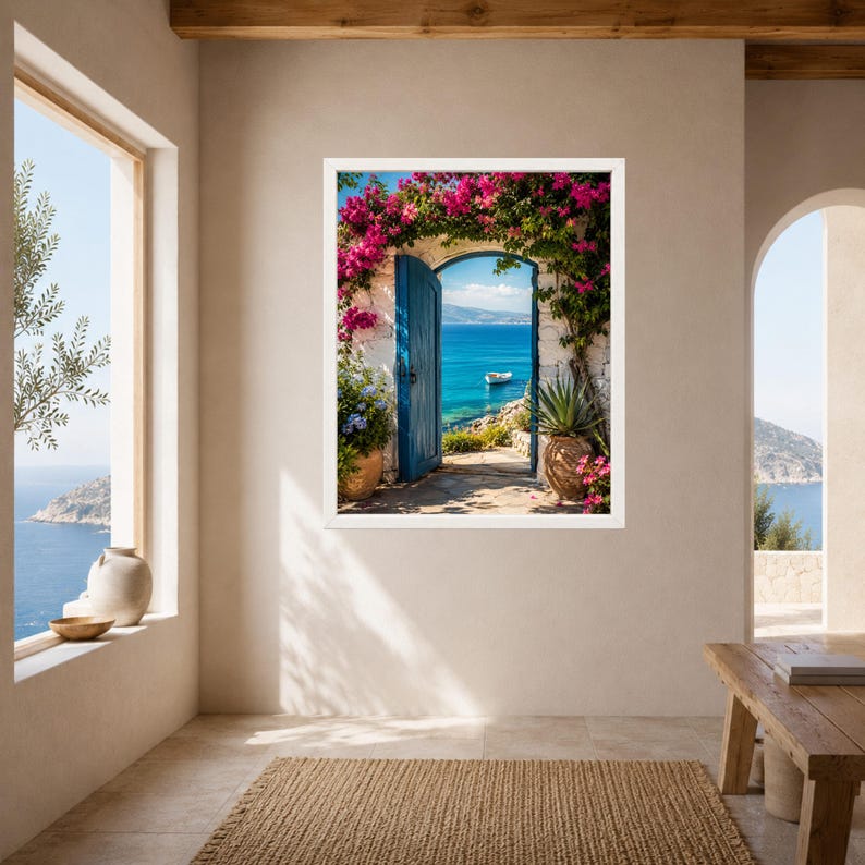 May include: A framed wall art print depicting an open blue door set in a white stone archway, framed by vibrant pink bougainvillea flowers. The view through the doorway reveals a bright blue sea with a small white boat under a clear sky.