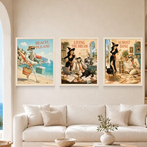 May include: Three framed wall art prints featuring vintage-style illustrations. The left print shows a skeleton at the beach with the text BEACH, PLEASE. The center print shows a witch and skeleton in an office with LIVING THE DREAM. The right print shows a witch and skeleton with the text ALMOST DONE.