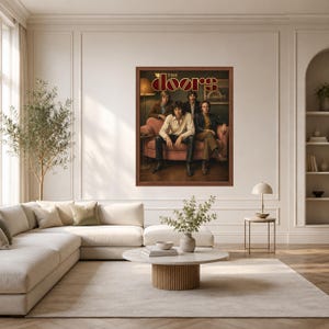 May include: A framed rectangular wall poster featuring the rock band The Doors. The image shows four band members sitting on a pink sofa in a dimly lit room. The text THE DOORS is printed in a stylized gold and red font at the top of the poster.