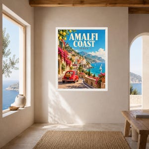 May include: A framed travel poster featuring the Amalfi Coast in Italy, displaying a red vintage car on a coastal road, vibrant pink bougainvillea, lemon trees, and sailboats on the blue sea, with the text AMALFI COAST ITALY at the top.