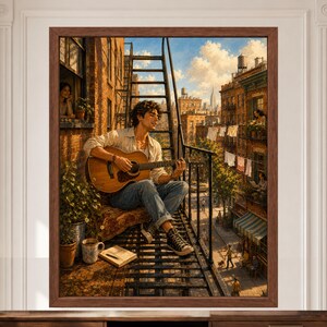 May include: A framed wall art print depicting a person sitting on a metal fire escape playing an acoustic guitar. The scene shows a city street with brick buildings, laundry hanging on lines, potted plants, and a blue sky with white clouds.
