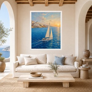 May include: A framed wall art print featuring a sailboat with white sails navigating deep blue waters during a golden sunset. In the background, a hillside village with white buildings overlooks the sea under a soft, cloud-filled orange sky.