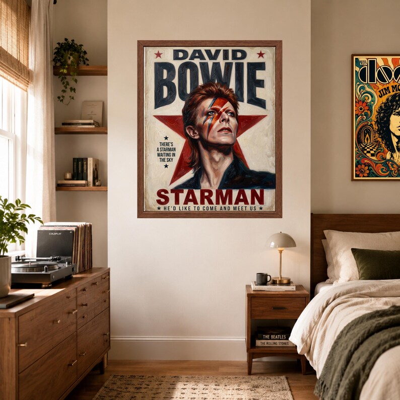 May include: A framed wall poster featuring a portrait of David Bowie with his iconic lightning bolt makeup. The text reads DAVID BOWIE, STARMAN, THERE'S A STARMAN WAITING IN THE SKY, and HE'D LIKE TO COME AND MEET US, set against a large red star.