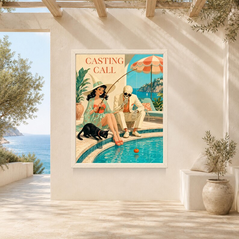 May include: A framed wall art print titled CASTING CALL featuring a woman in a witch hat and a skeleton in a suit sitting by a swimming pool. The woman wears a green dress and holds a fishing rod, while a black cat sits nearby. The scene includes a beach umbrella, blue water, and a coastal landscape.